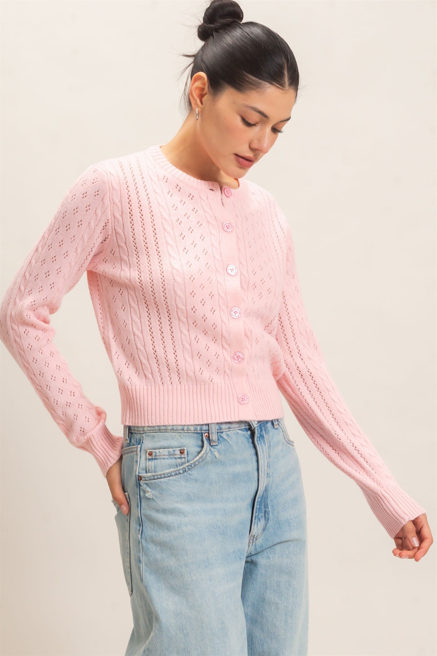 A timeless cable knit cardigan with a classic crew neckline, button-front closure, and textured detailing for cozy, polished style.