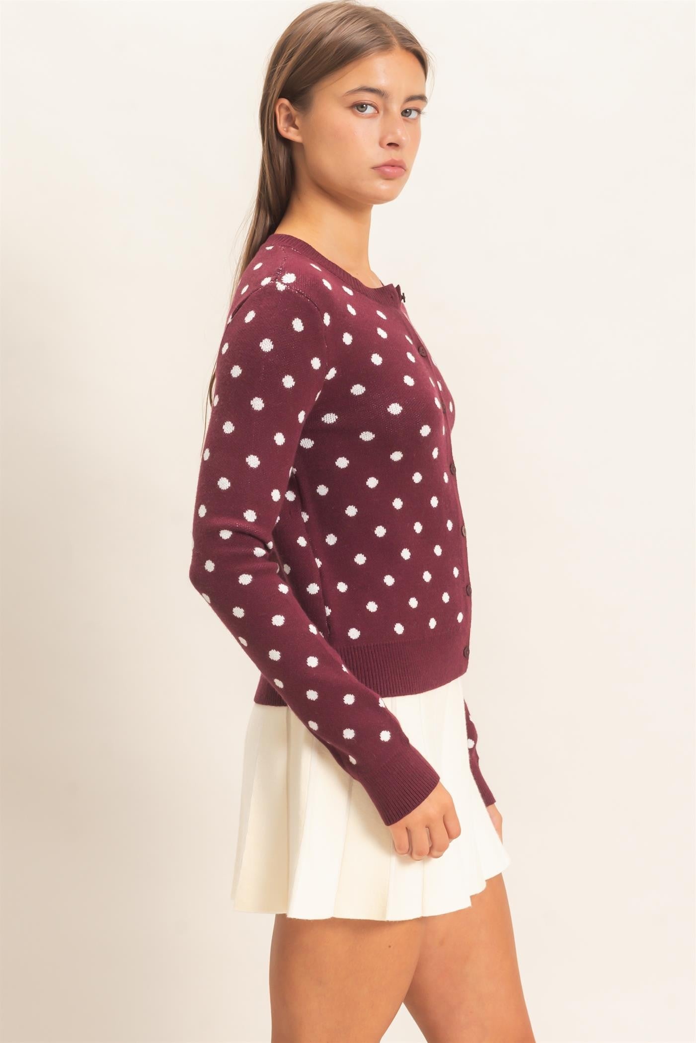 A timeless polka dot cardigan with a classic crew neckline and button-front design that adds effortless charm to everyday and office-ready looks.
