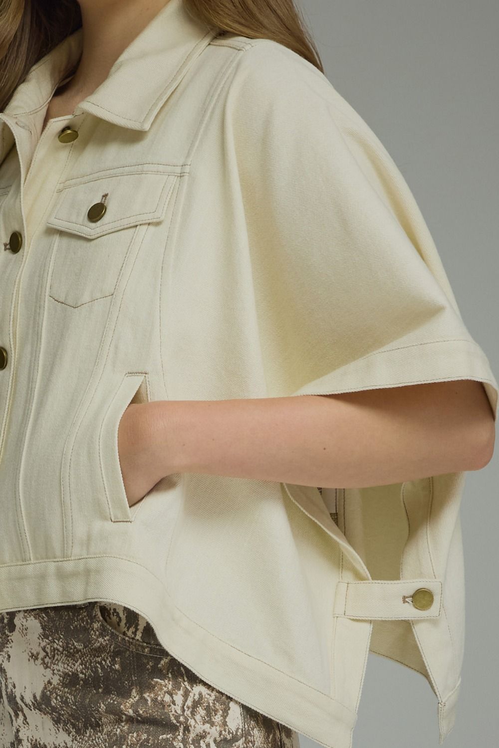 A versatile denim short sleeve jacket with snap-button closures, multiple pockets, and a timeless structured silhouette made for effortless layering.

