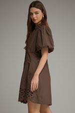 The Winifred Eyelet Collar Mini Dress combines romantic puff sleeves, delicate eyelet details, and a flattering pleated waist for effortlessly feminine style.