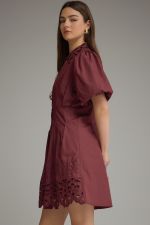 The Winifred Eyelet Collar Mini Dress combines romantic puff sleeves, delicate eyelet details, and a flattering pleated waist for effortlessly feminine style.