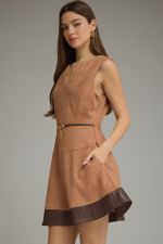 A chic faux suede mini dress featuring a flattering belted waist, faux leather hem, V-neckline, and convenient side pockets.

