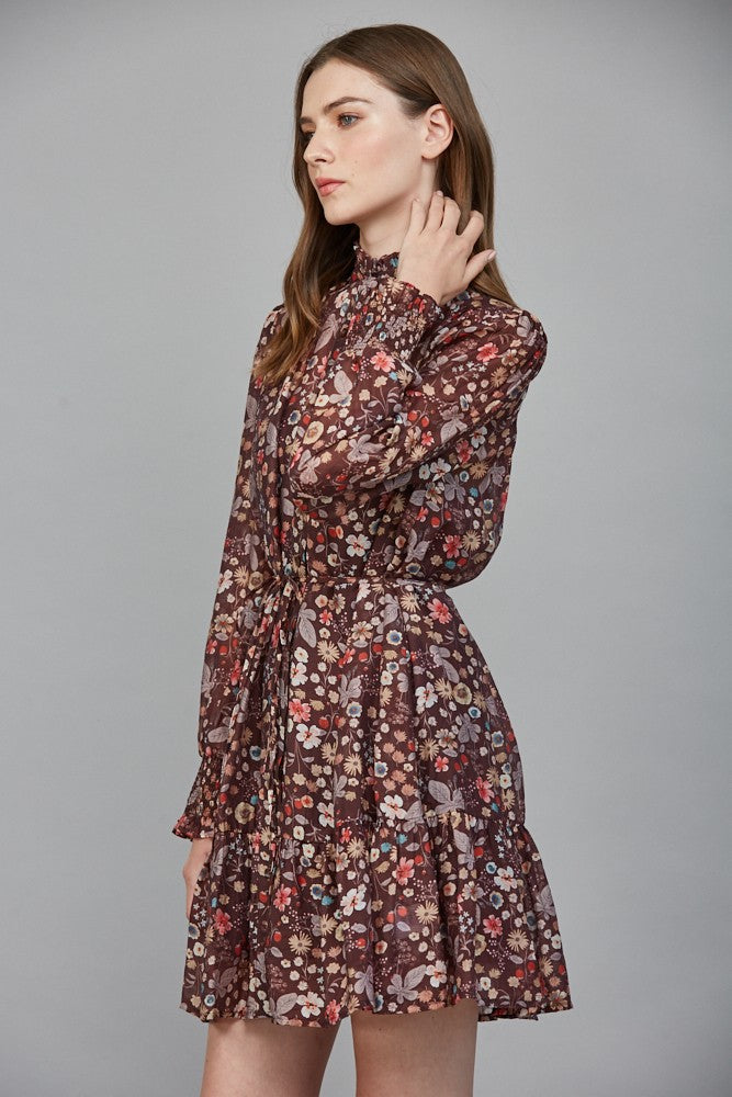 A romantic floral print dress featuring a ruffled high neckline, flattering tie waist, and flowing silhouette for effortlessly elegant style.