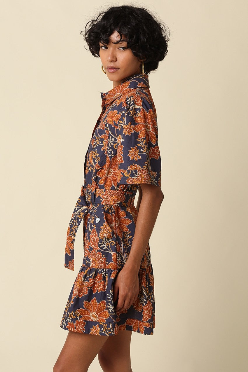 The Adele Floral Belted Mini Dress brings vintage-inspired charm to your wardrobe with a feminine fit-and-flare silhouette, button-front design, and playful tiered ruffle hem.