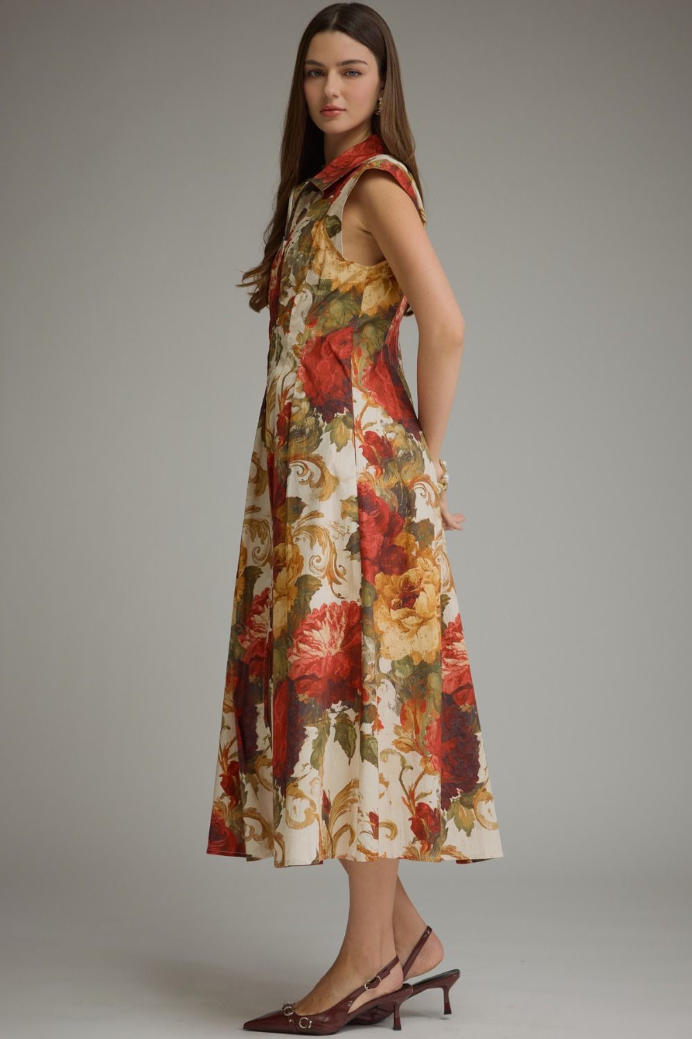 A feminine floral midi dress featuring a flattering foldover neckline, convenient front zipper, and effortless everyday elegance.