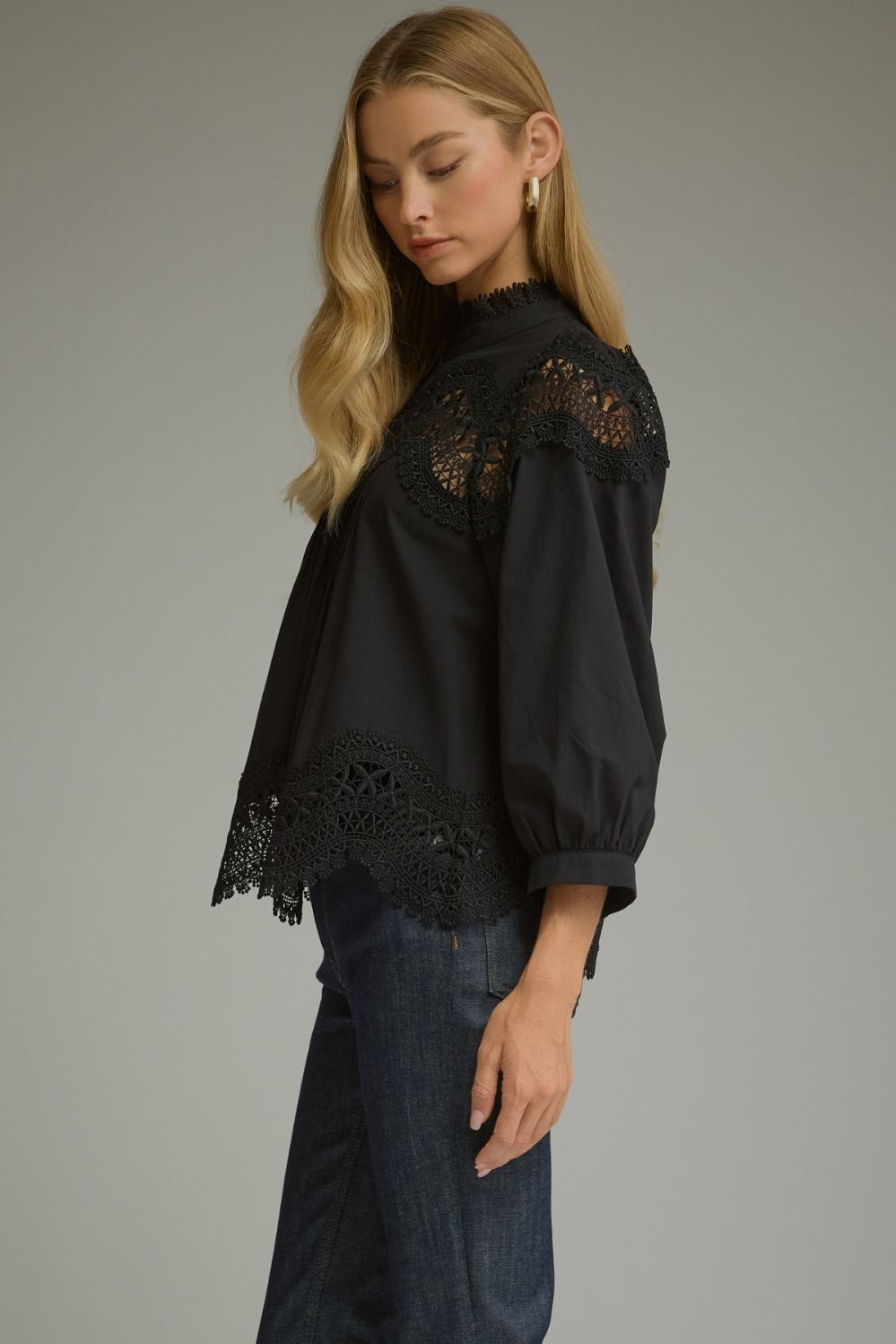 A romantic ¾ sleeve top featuring elegant pintuck detailing, delicate lace trim, and a refined mock neckline.