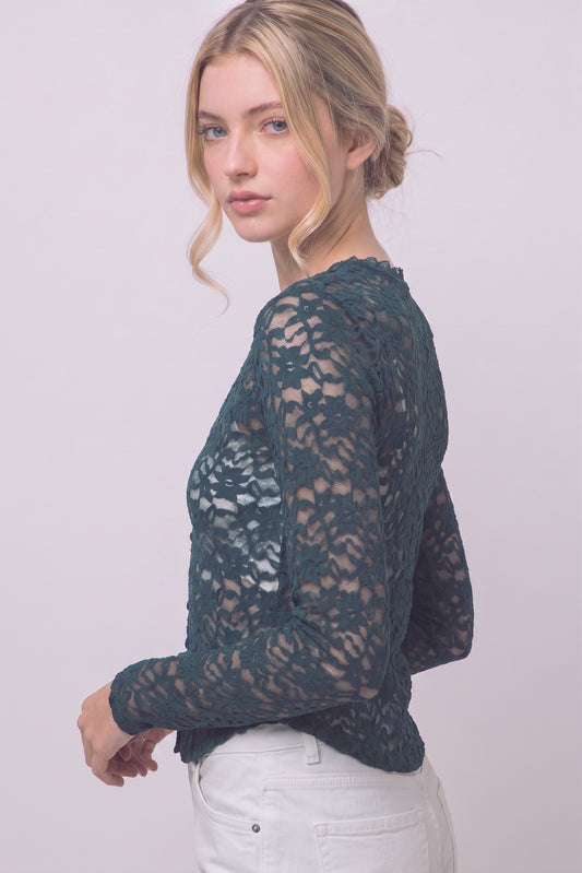 A romantic sheer floral lace top featuring long sleeves, a scalloped V-neckline, delicate trim details, and matching front buttons for an effortlessly feminine look.