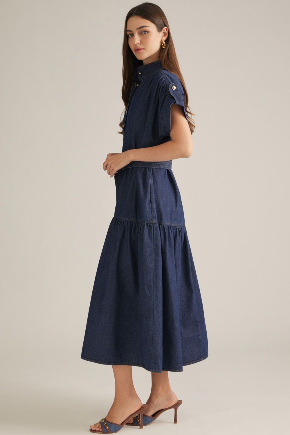 A timeless solid midi dress featuring a structured stand collar, cap sleeves, partial button front, and self-tie waist for an effortlessly polished silhouette.