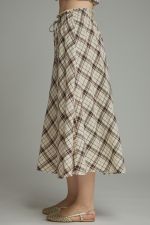 A breezy plaid midi skirt featuring a flattering self-tie waist and feminine ruffle detailing for effortless everyday elegance.

