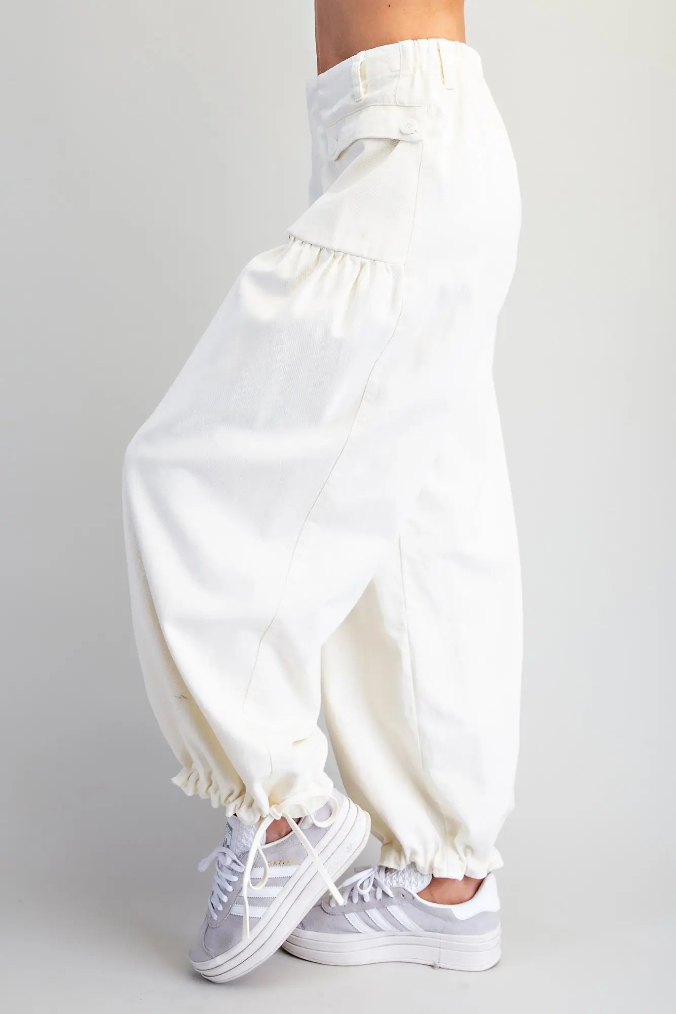 Relaxed mineral washed harem pants featuring adjustable tie cuffs, utility-inspired pockets, and a comfortable elastic back waistband for effortless everyday style.