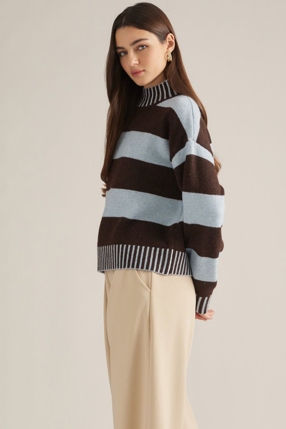 A cozy striped sweater featuring a classic mock neckline, long sleeves, and ribbed trim for an effortlessly polished cold-weather look.