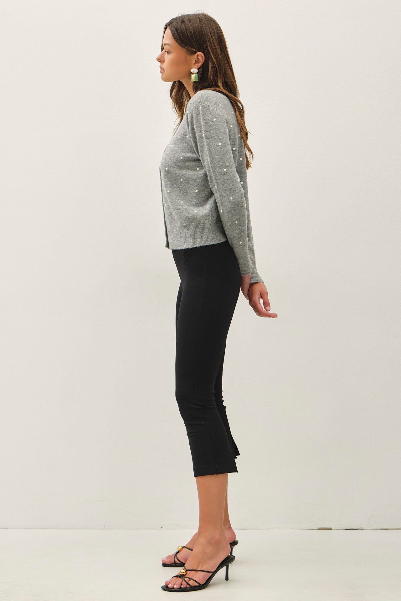 a light gray knit cardigan with small white embroidered dots and button-front closure, crew neckline,