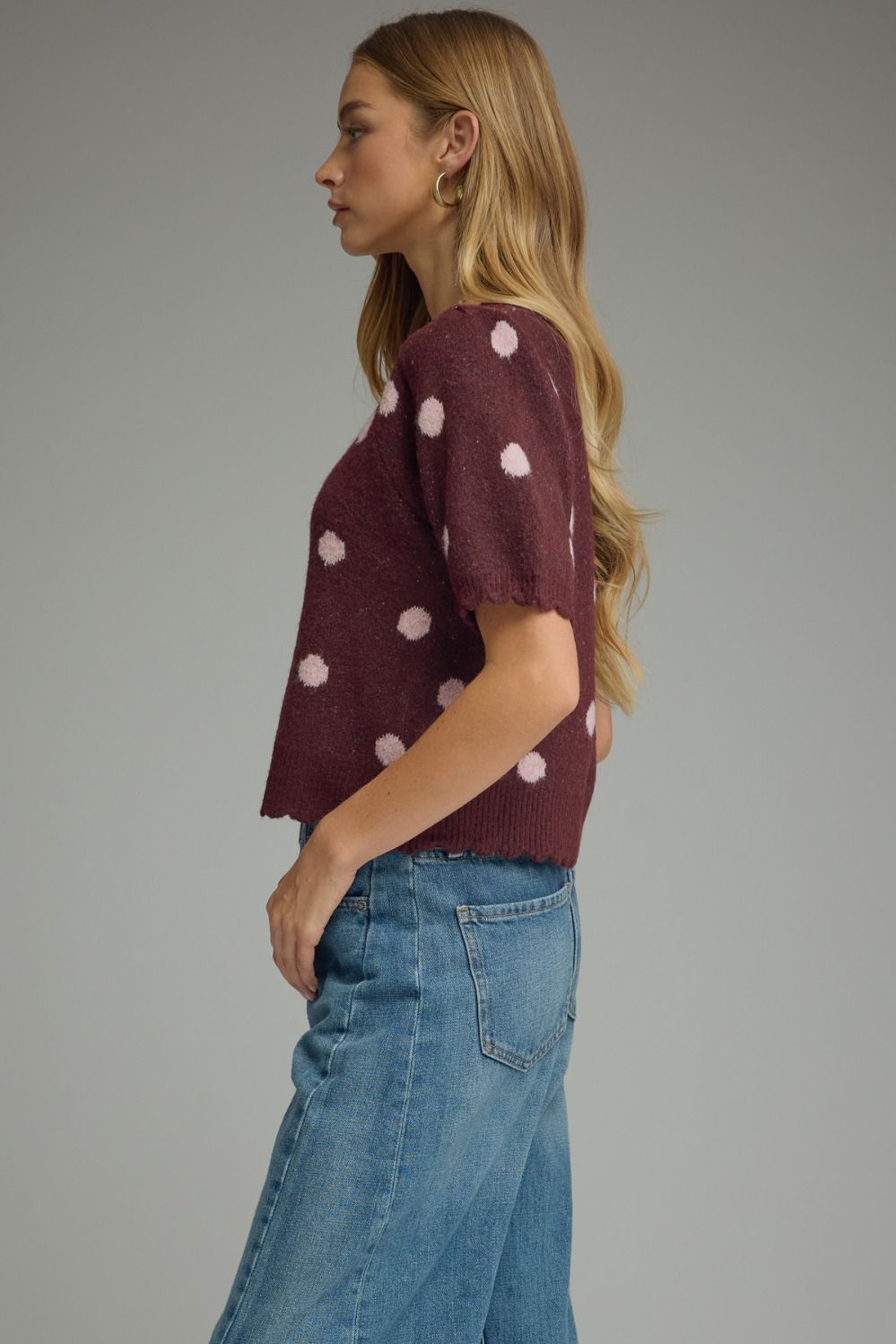 side of effortlessly versatile, this lightweight polka dot knit top features feminine puff sleeves and delicate scalloped trim for timeless boutique style.