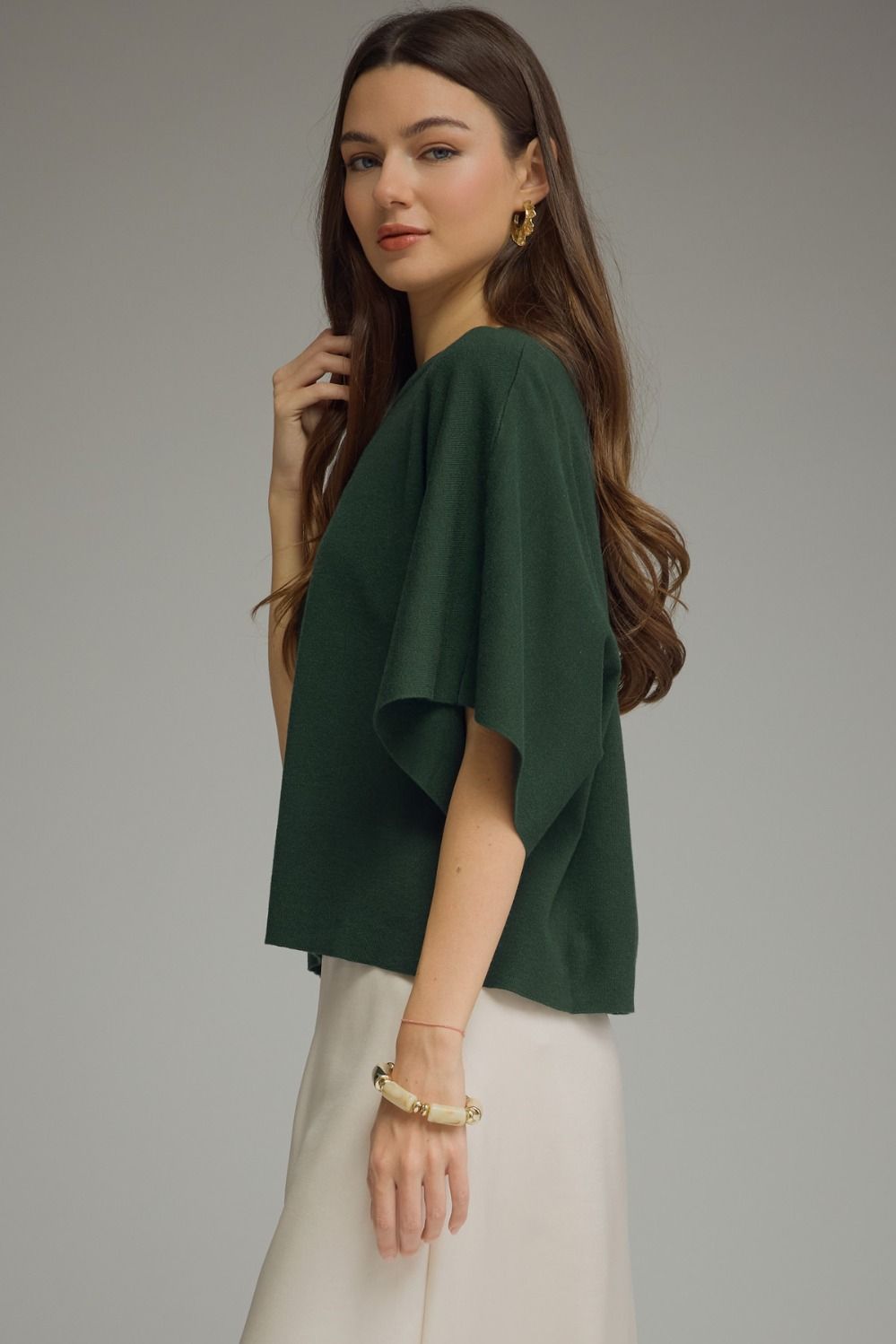 A versatile solid knit top featuring a classic round neckline and lightweight, non-sheer fabric for effortless everyday style.