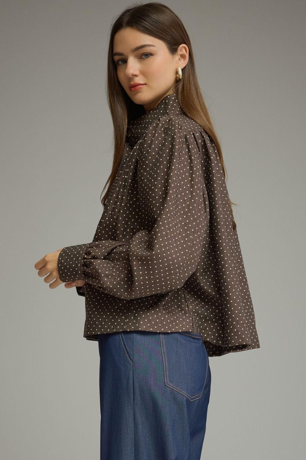 A chic polka dot jacket featuring a polished stand collar, gathered shoulder details, and classic button-front styling in lightweight woven fabric.

