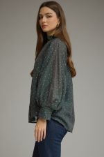 A lightweight polka dot blouse featuring a feminine ruffled neckline, button-front detail, and elegant long sleeves for effortless boutique style.