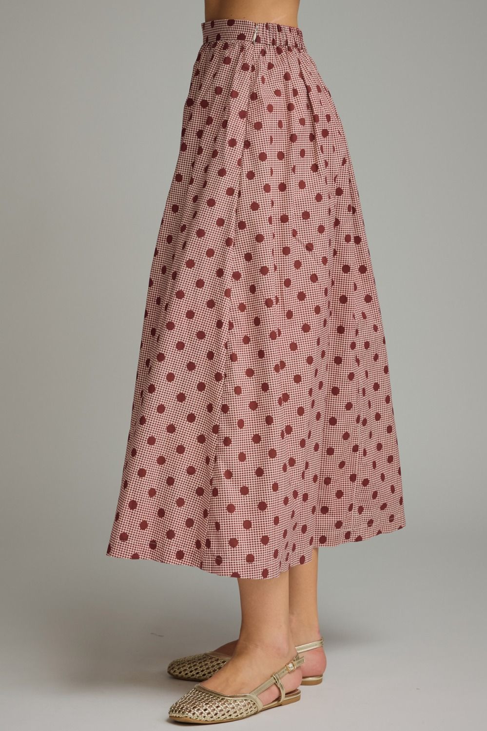 A charming gingham polka dot midi skirt featuring a gathered waist, functional pockets, and a lightweight lined design for effortless feminine style.