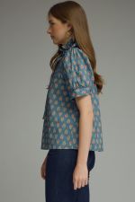  printed puff sleeve blouse features a feminine ruffle neckline, self-tie detail, and timeless button-front styling.
