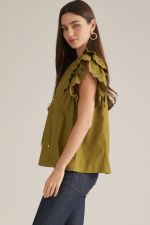 A feminine sleeveless top featuring a split neckline, front self-tie, and layered shoulder ruffles finished with delicate eyelet trim.

