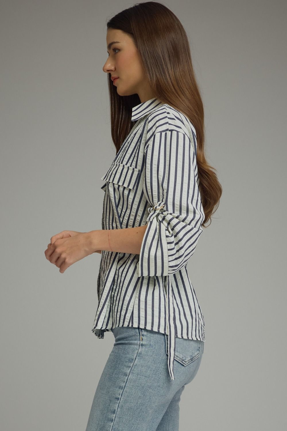 A lightweight striped woven top featuring a foldover neckline, adjustable sleeve tabs, and polished details for effortless everyday style.