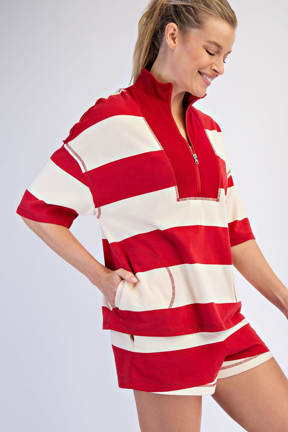 A lightweight striped cotton top with a sporty quarter-zip neckline, relaxed oversized fit, and effortlessly cool raw-edge details.