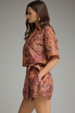 A feminine botanical print two-piece set featuring a breezy split-V top and wrap-front skort for effortless warm-weather style.