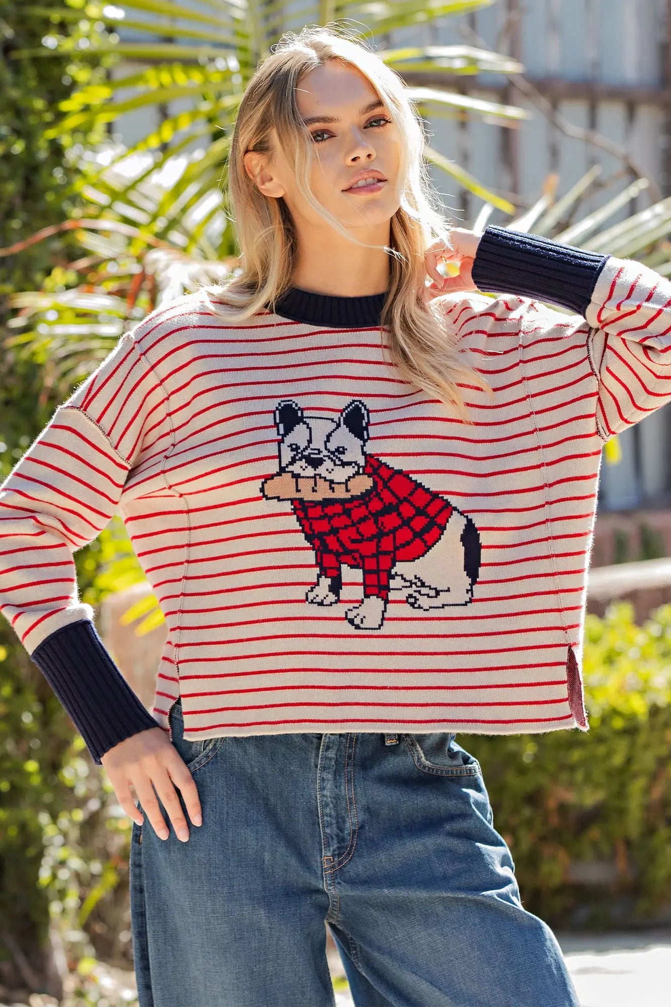 A cozy striped knit sweater featuring an adorable bulldog graphic, relaxed drop shoulders, and side slits for playful boutique style