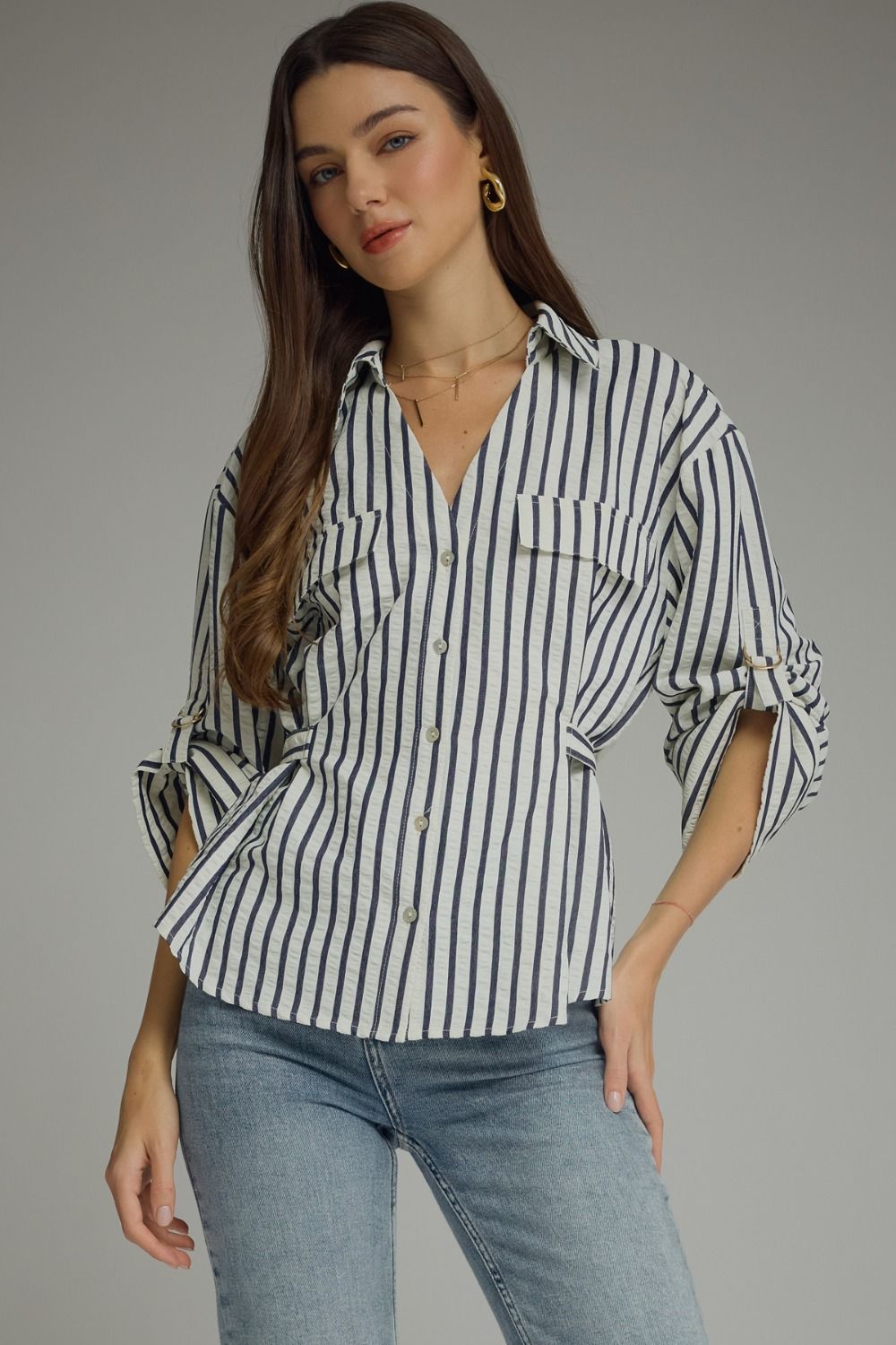 A lightweight striped woven top featuring a foldover neckline, adjustable sleeve tabs, and polished details for effortless everyday style.
