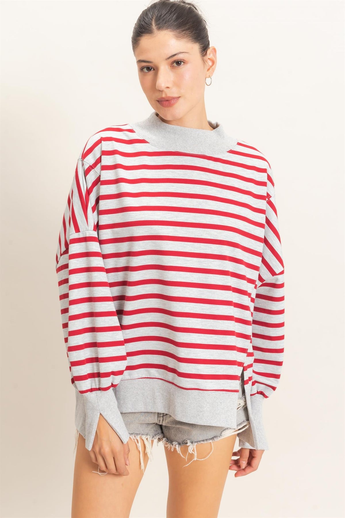 A relaxed striped sweatshirt featuring a cozy mock neck, ribbed cuffs, and a split hem for effortless everyday style.

