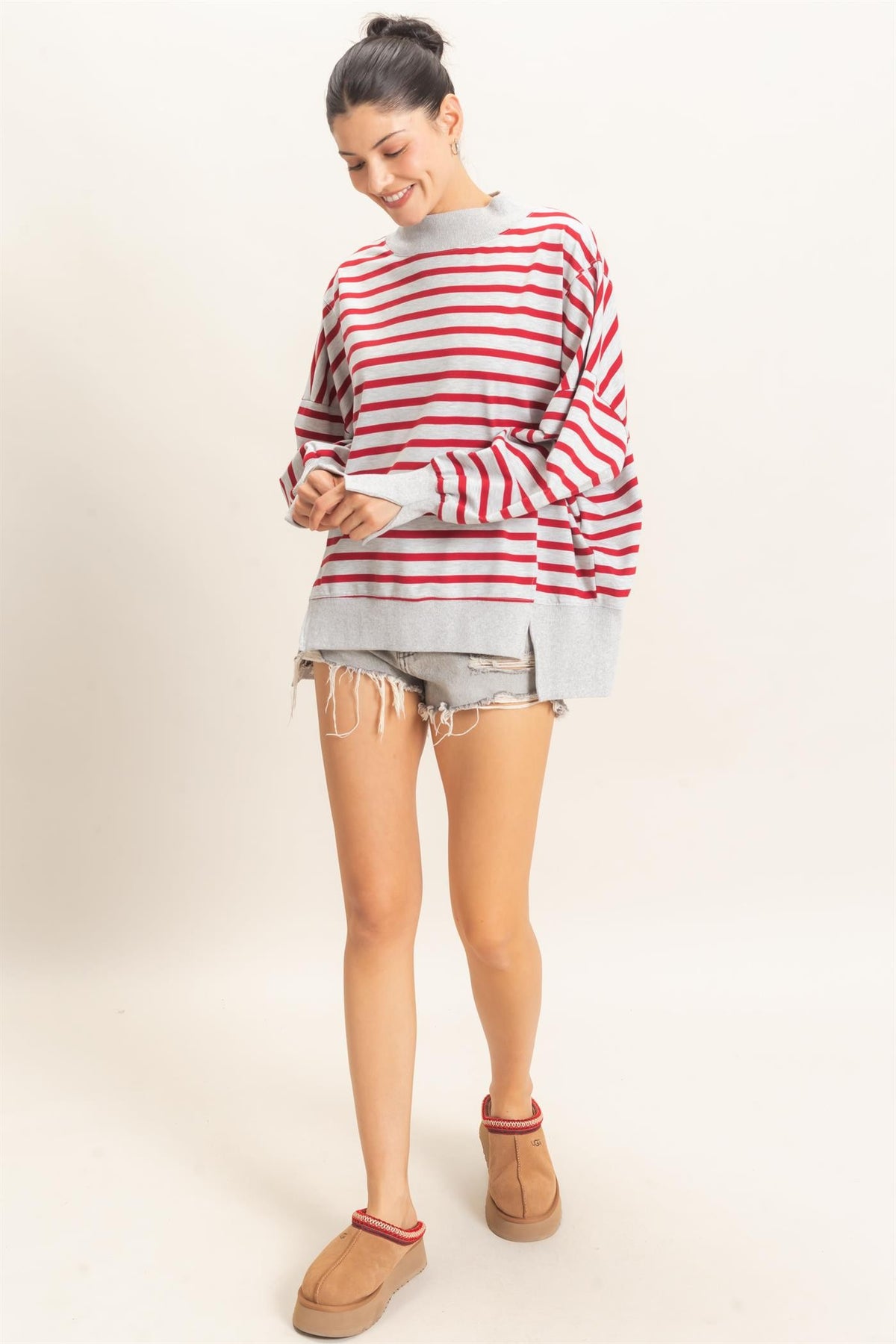A relaxed striped sweatshirt featuring a cozy mock neck, ribbed cuffs, and a split hem for effortless everyday style.

