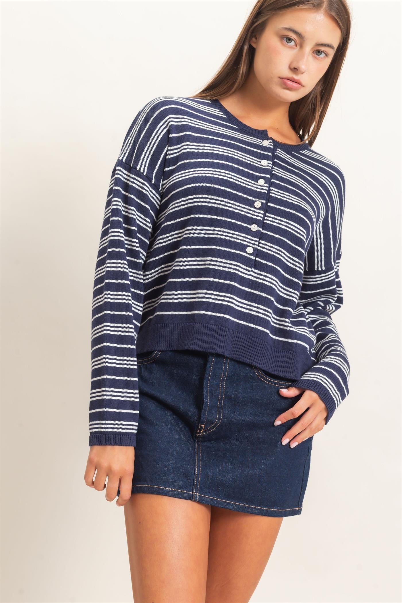 A classic striped ribbed sweater with a modern henley neckline and cozy long sleeves, perfect for effortless everyday style.
