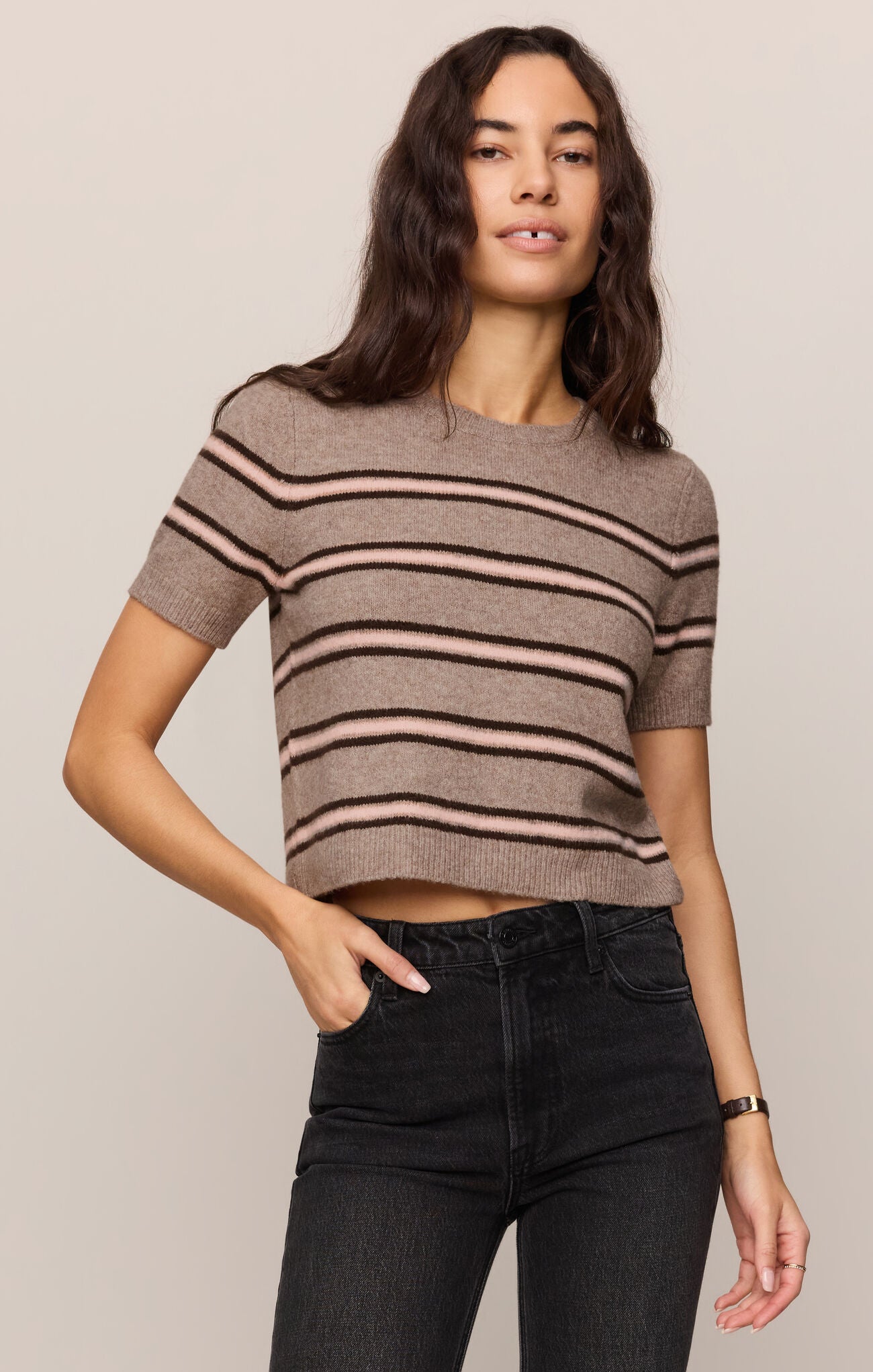 Woman wearing a striped sweater in brown and tan