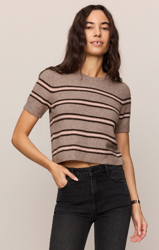 Woman wearing a striped sweater in brown and tan