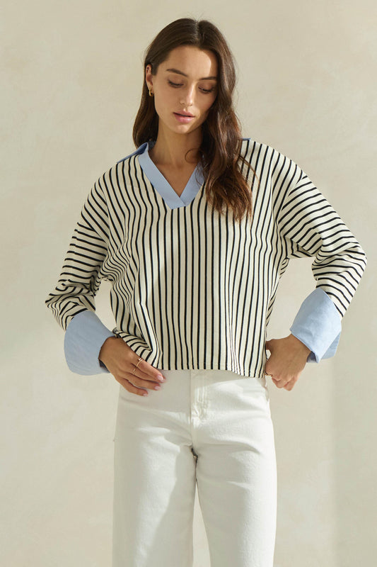 A timeless striped knit top featuring a flattering V-neckline, contrast neckline and cuffs, and an effortlessly polished silhouette.