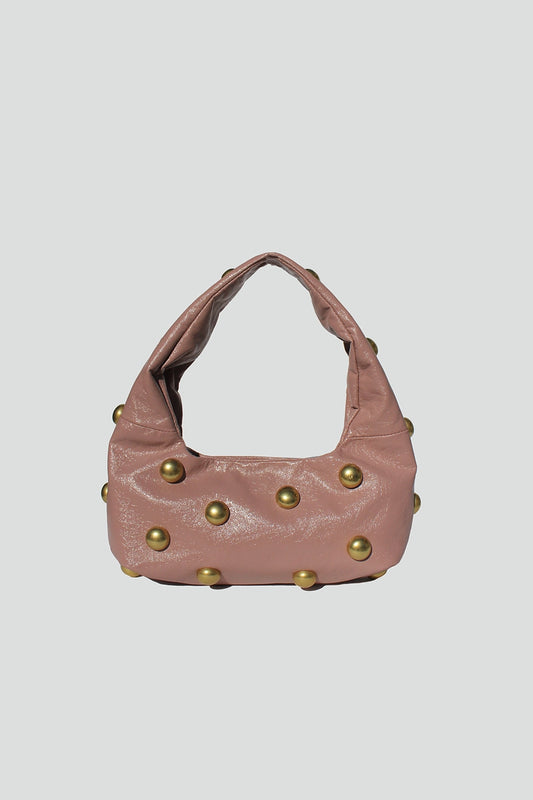 A chic everyday shoulder bag crafted from vegan leather and finished with gold-tone stud details for an elevated touch of edgy sophistication.



