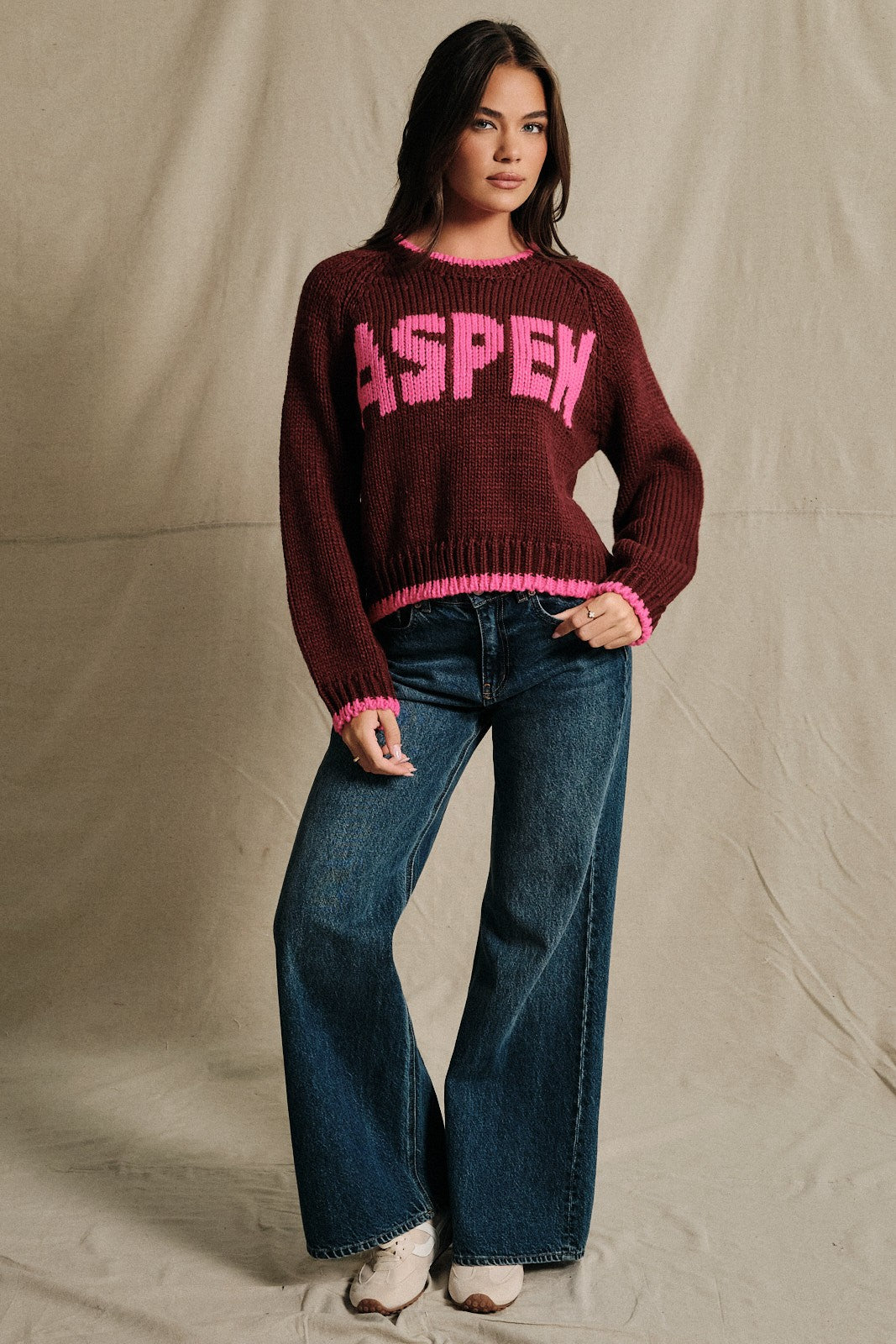 A chunky knit pullover with bold statement lettering and contrast ribbed trim for a cozy, après-ski-inspired look all winter long.

