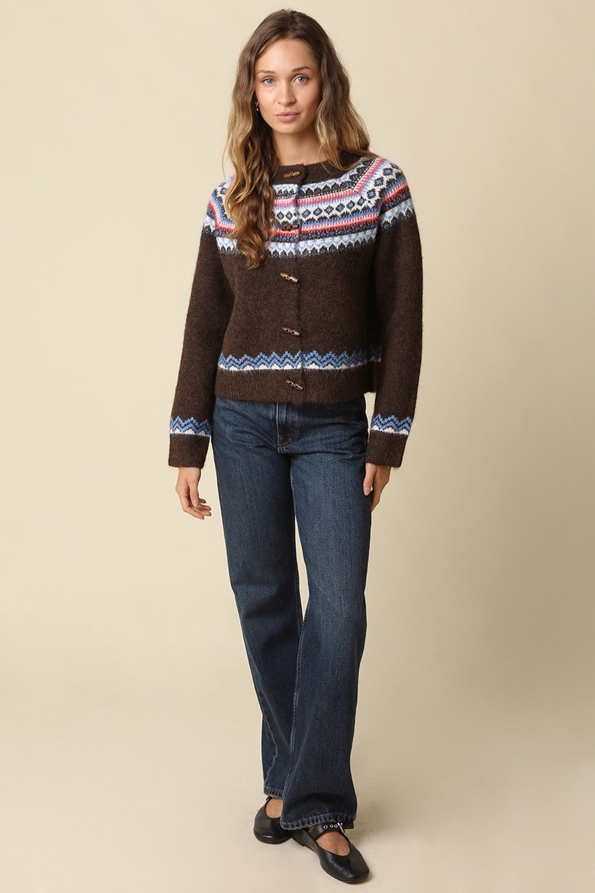 A cozy wool-blend knit cardigan featuring a classic Fair Isle pattern, charming toggle closures, and timeless Nordic-inspired style for chilly days.

