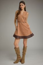 A chic faux suede mini dress featuring a flattering belted waist, faux leather hem, V-neckline, and convenient side pockets.

