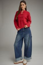 A cozy, polished sweater featuring a high neckline, statement frog-button closure, and relaxed drop shoulders for timeless style with a modern twist.

