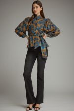 A feminine floral peplum top featuring romantic balloon sleeves, a stand collar, and a flattering tie waist for a beautifully defined silhouette.a