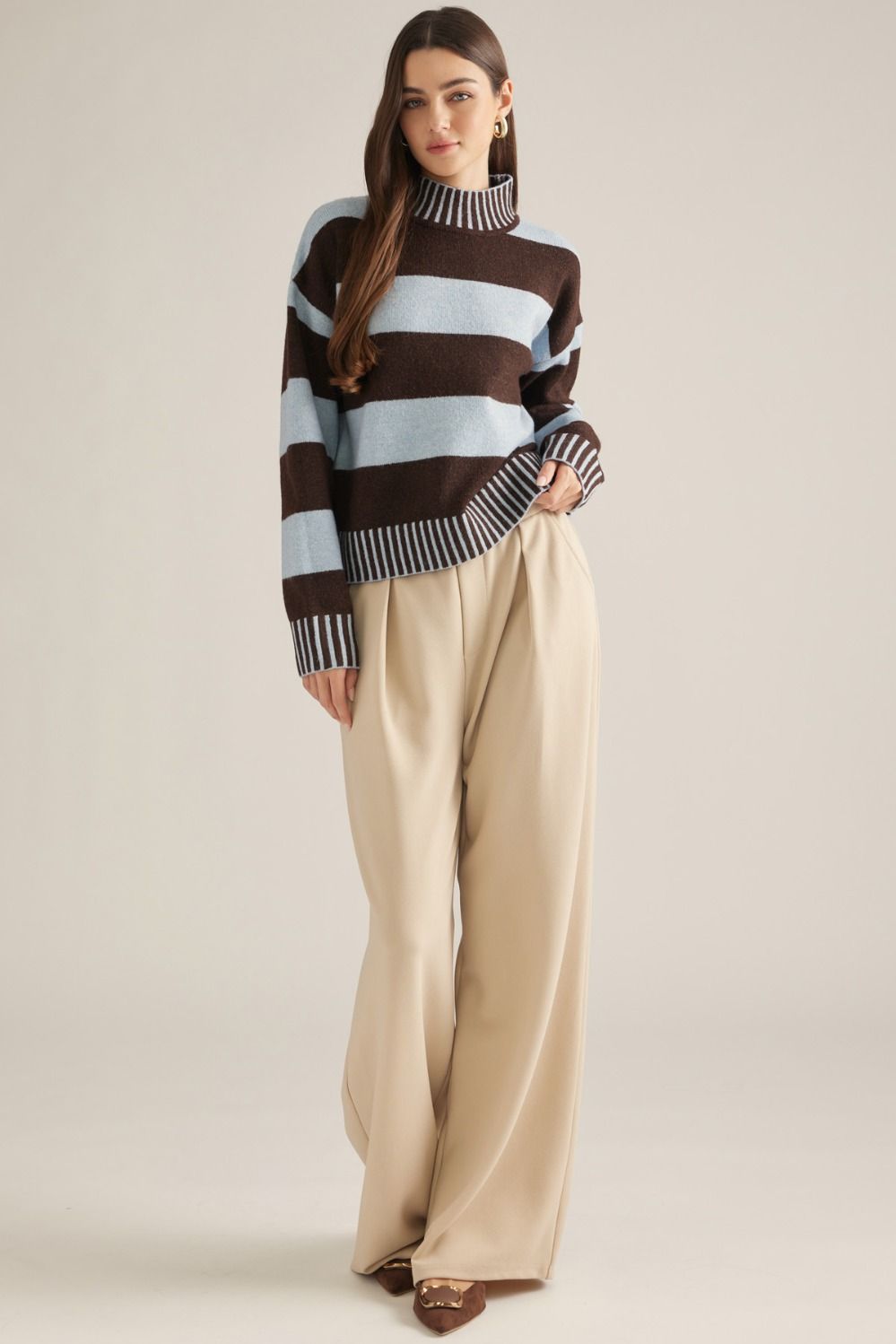 A cozy striped sweater featuring a classic mock neckline, long sleeves, and ribbed trim for an effortlessly polished cold-weather look.