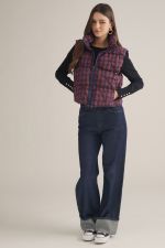 A cozy-chic plaid vest featuring a high neck, padded quilted construction, and a convenient front zipper for effortless layering through the cooler seasons.
