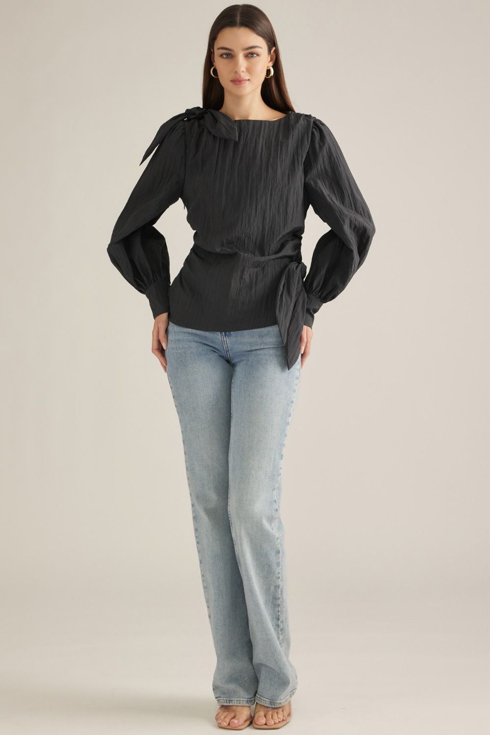 Elevate your wardrobe with this chic long-sleeve blouse featuring a straight neckline, feminine shoulder tie, and flattering side-wrap detail.

