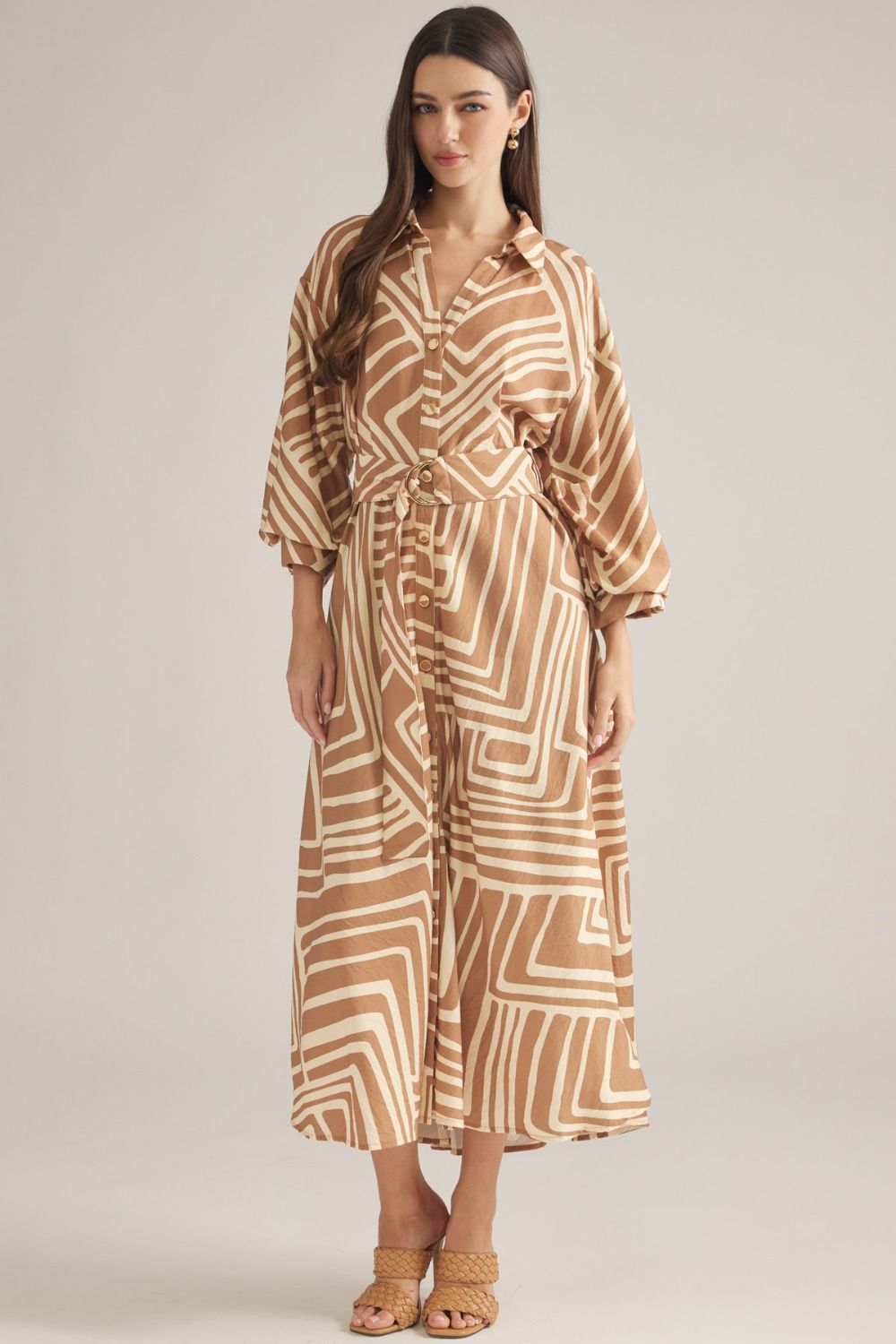 A sophisticated geometric print midi dress featuring balloon sleeves, a removable belt, and a flattering button-front silhouette.
