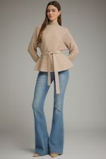A polished ribbed peplum sweater with a flattering self-tie waist and mock neckline for an effortlessly feminine, put-together look.