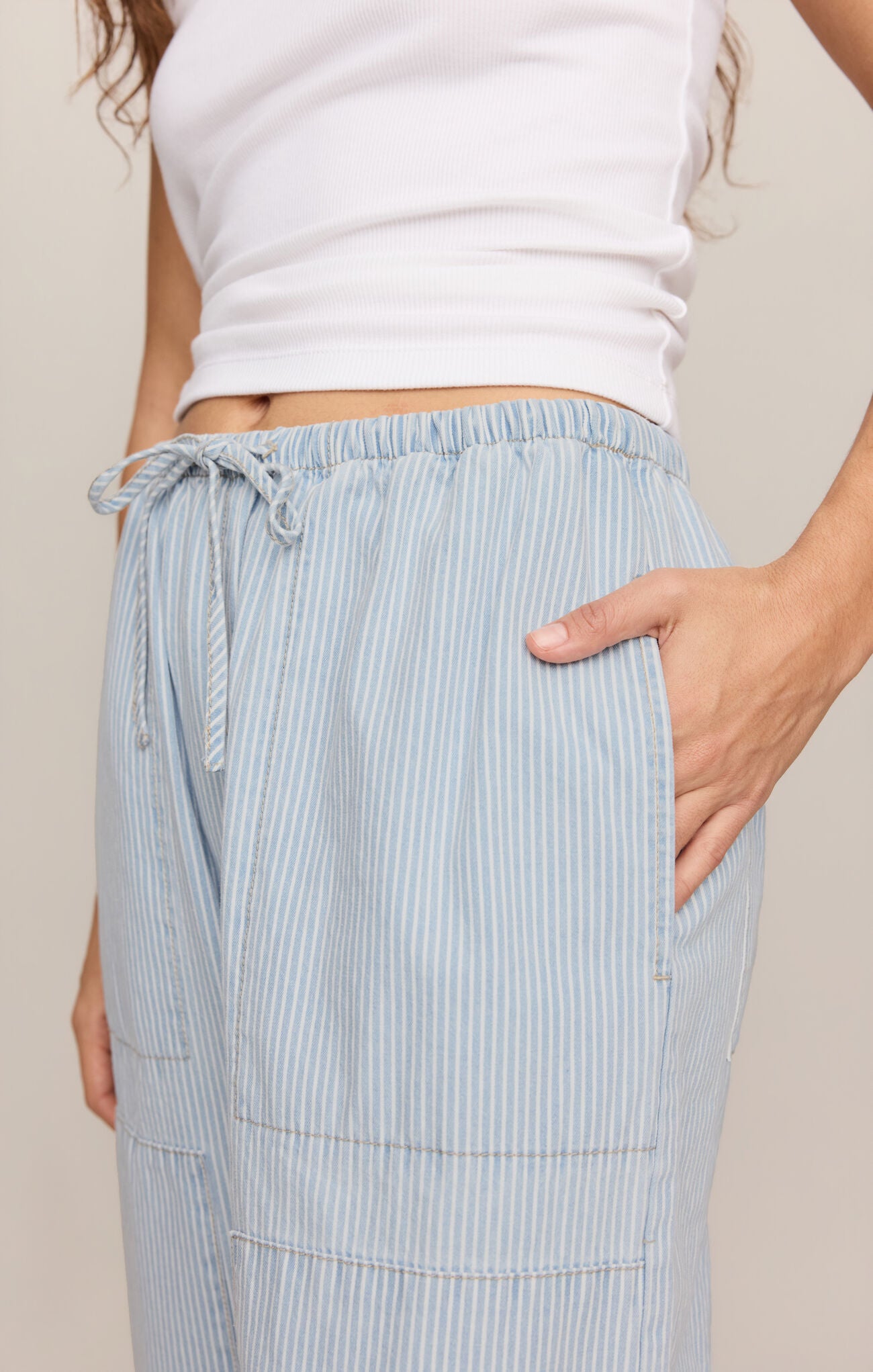 front pockets of High-rise cotton denim pants featuring a striped print and tie-front detail