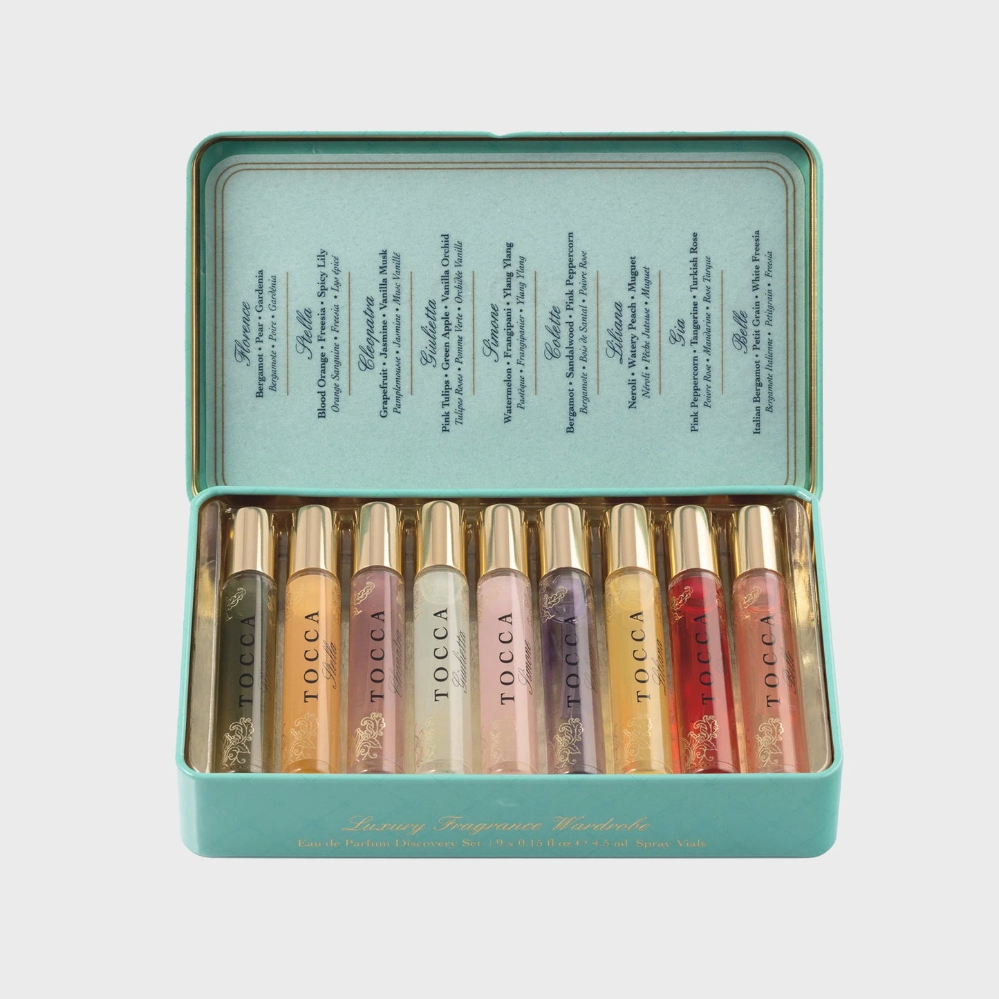 Set of Tocca perfumes  in a teal tin on a light gray background