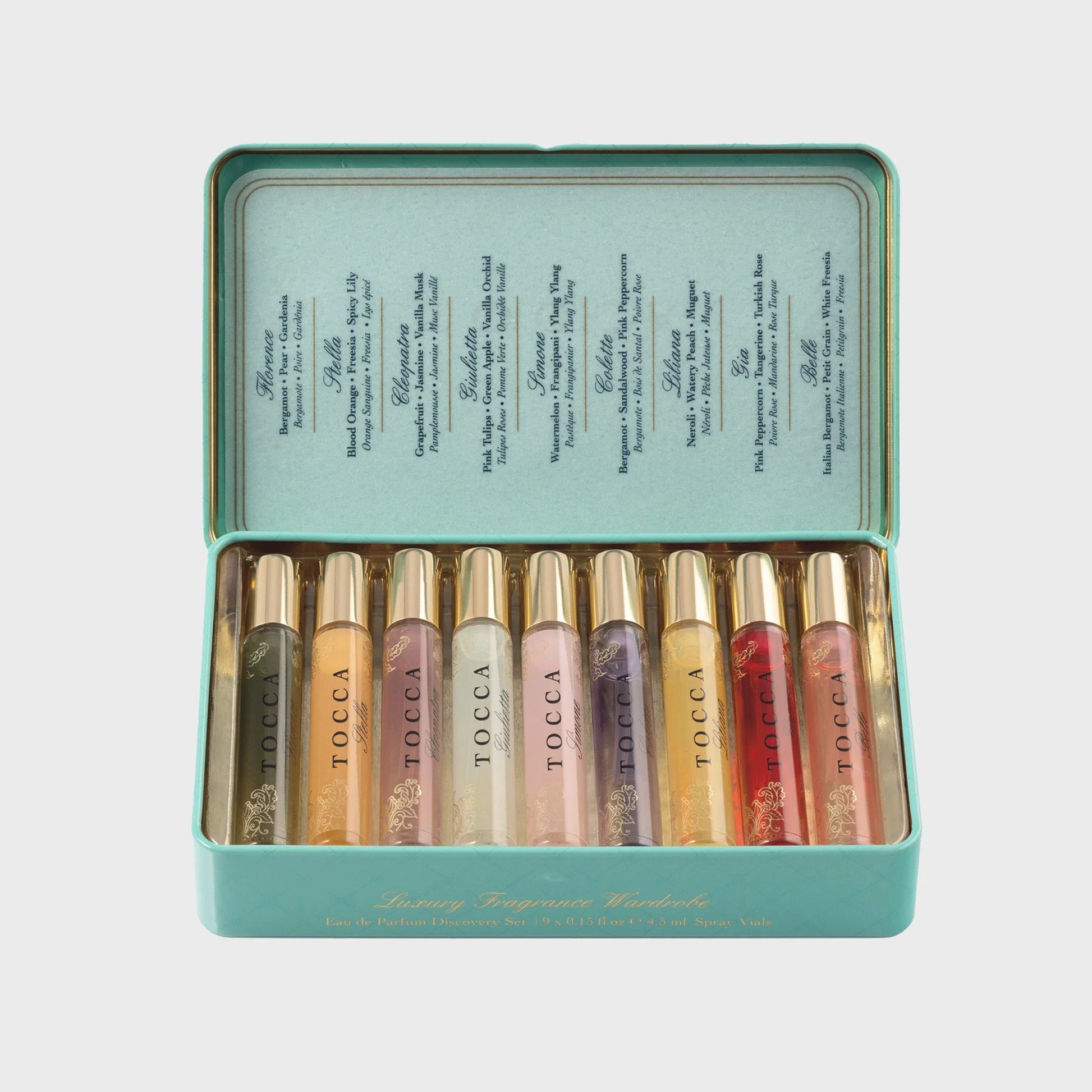 Set of Tocca perfumes  in a teal tin on a light gray background
