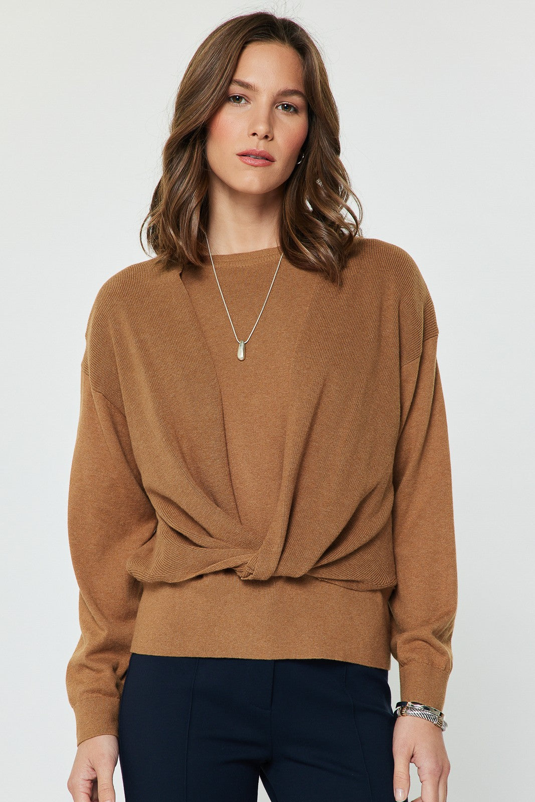 A beautifully soft knit sweater with a relaxed fit, elegant twist-front detail, and flowing dolman sleeves for effortless everyday style.