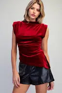A sophisticated velvet top with feminine cap sleeves, flattering waist ruching, and a fitted silhouette designed for polished evening style.